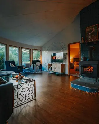a living room with a couch and a fireplace at Idyllic Mountain Stay Hot Tub, Wood Stove, Games in Windham