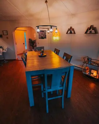a blue table and chairs in a living room at Idyllic Mountain Stay Hot Tub, Wood Stove, Games in Windham