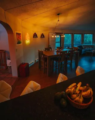 a kitchen and dining room with a table with a bowl of bananas at Idyllic Mountain Stay Hot Tub, Wood Stove, Games in Windham