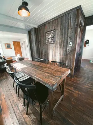 a dining room with a wooden table and chairs at Charming Mtn Stay Views, Hot Tub, Prime Location in West Kill