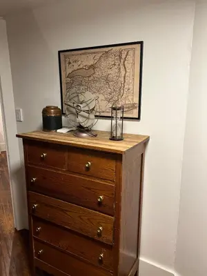 a wooden dresser with a map on the wall at Charming Mtn Stay Views, Hot Tub, Prime Location in West Kill
