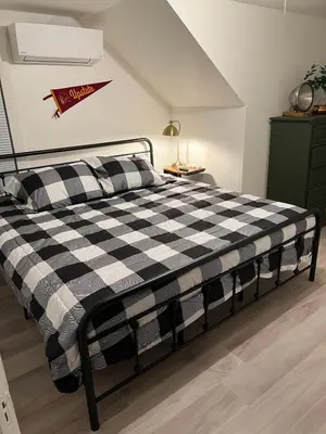 a bedroom with a black and white checkered bed at Charming Mtn Stay Views, Hot Tub, Prime Location in West Kill