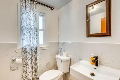 a bathroom with a toilet and a sink and a mirror at Work, Explore and Relax Centrally Located Union Gem in Union