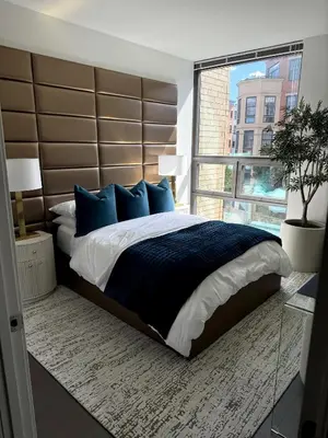 a bedroom with a large bed with a large window at NEWLuxe 2bd2ba w Pool & More in Hoboken