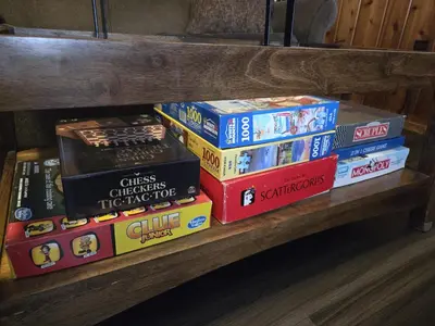 a pile of books sitting on a wooden shelf at Newton Lake in Malinchak Airport
