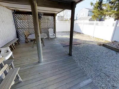 a wooden deck with a picnic table and a bench at Great Value - Oceanside Raised Ranch Location Is Perfect For Walking To Beach, Restaurants, Pizza, Ice Cream Or Coffee 13419 in Upper Greenwood Lake