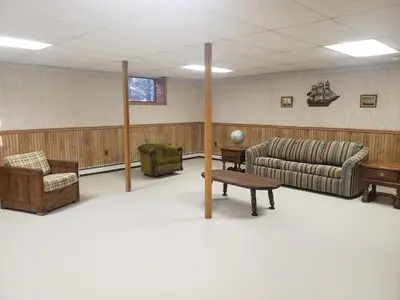 a waiting room with a couch and a table at Kaaterskill Waterfall House in Haines Falls