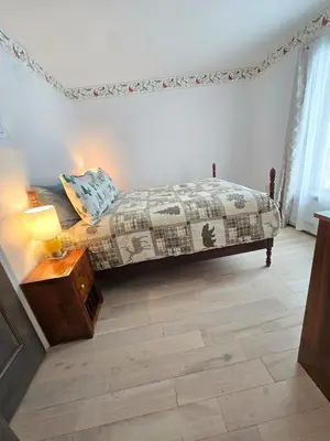 a bedroom with a bed and a table with a lamp at Kaaterskill Waterfall House in Haines Falls