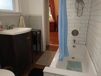 a bathroom with a tub and a sink and a shower at Comfortable 2 Bedroom House with Big Yard 30 Minutes to New York City in Ridgefield Park