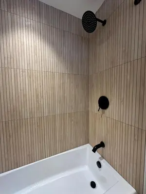 a bathroom with a white tub and a fan at Cozy Cabin with Fireplace, Games, Coffee on 5 Acres in Hunter