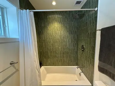 a bathroom with a bath tub and a shower at Cozy Cabin with Fireplace, Games, Coffee on 5 Acres in Hunter
