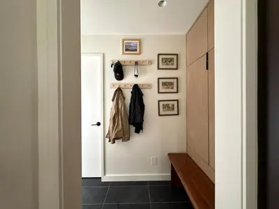 a hallway with a door and a coat rack at Cozy Cabin with Fireplace, Games, Coffee on 5 Acres in Hunter