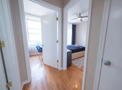 a room with a bedroom with a bed and a window at 3BR apt two blocks to Central Park elevator, laundry, virtual doorman in New York