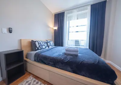 a bedroom with a bed and a window at 3BR apt two blocks to Central Park elevator, laundry, virtual doorman in New York