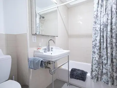 a bathroom with a sink and a toilet and a tub at 3BR apt two blocks to Central Park elevator, laundry, virtual doorman in New York