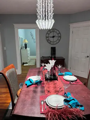 a dining room with a table with a red table cloth at Eden's Lodge in East Hartford