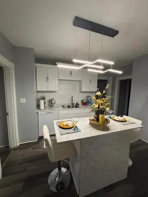 a kitchen with a island in the middle of a room at Eden's Lodge in East Hartford