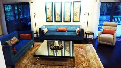 a living room with two blue couches and a table at The Woodridge Retreat in Goshen