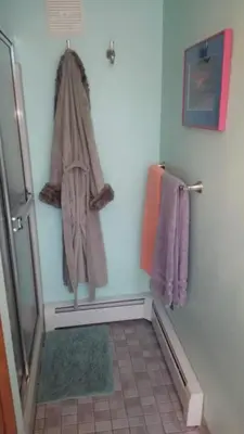 a bathroom with a towel hanging on the wall at The Woodridge Retreat in Goshen