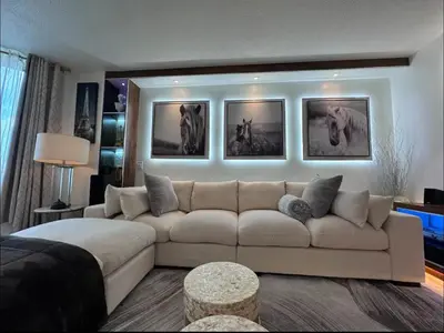 a living room with a white couch and pictures on the wall at NEW Chic & Cozy 1BD Apartment Near East River, Minutes from Central Park in New York