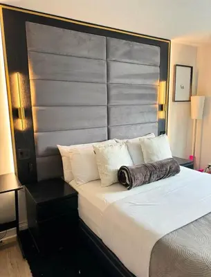 a bedroom with a large bed with a large headboard at NEW Chic & Cozy 1BD Apartment Near East River, Minutes from Central Park in New York
