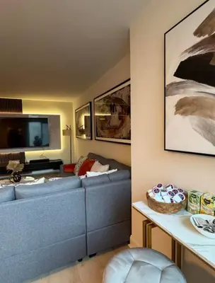 a living room with a blue couch and a tv at NEW Chic & Cozy 1BD Apartment Near East River, Minutes from Central Park in New York