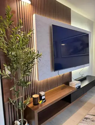 a flat screen tv sitting on top of a entertainment center at NEW Chic & Cozy 1BD Apartment Near East River, Minutes from Central Park in New York