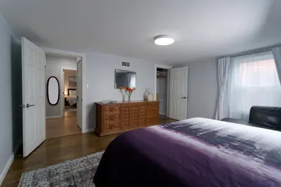 a bedroom with a bed and a dresser at Croton Quarters - Comfortable Apartments, NYC close in Croton-on-Hudson