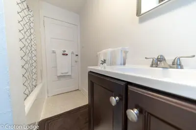 a bathroom with a sink and a bath tub at Croton Quarters - Comfortable Apartments, NYC close in Croton-on-Hudson