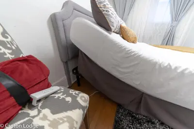 a bed and a couch in a room at Croton Quarters - Comfortable Apartments, NYC close in Croton-on-Hudson