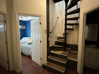 a hallway with a spiral staircase in a room at Max NY VIEW 5 Apartment Combo Sleeps 60 15 Mins to NYC in Union City