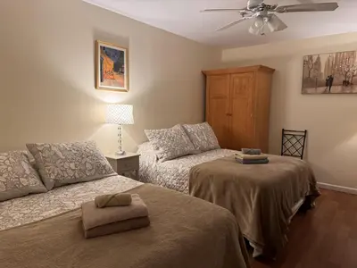 a bedroom with two beds and a ceiling fan at Ultra Spacious Penthouse - Apt 2 - 3 Combo -15 Mins from NYC in Union City