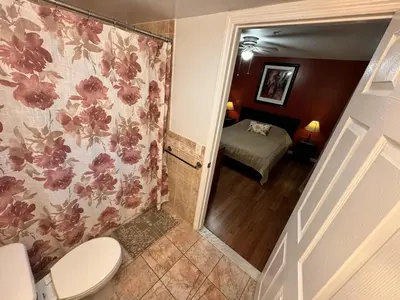 a bathroom with a toilet and a bed in a room at Ultra Spacious Penthouse - Apt 2 - 3 Combo -15 Mins from NYC in Union City