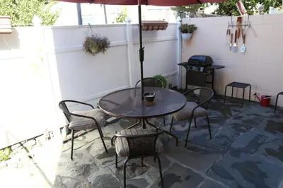a table and chairs with an umbrella on a patio at Ultra Spacious Penthouse - Apt 2 - 3 Combo -15 Mins from NYC in Union City