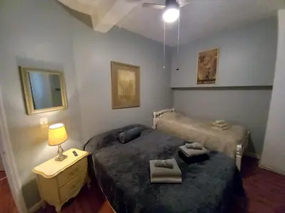 a bedroom with two beds and a table with a lamp at Triple See NY Now - Sleeps 41 -15 Mins to NYC in Union City