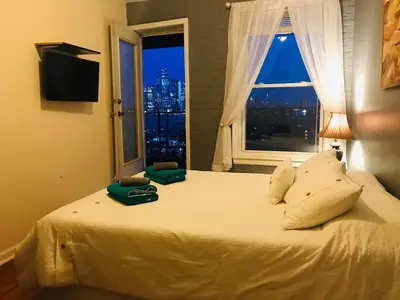 a bedroom with a large bed with a window at Mega Trade Stunning View - APT 3-4 Combination in Union City