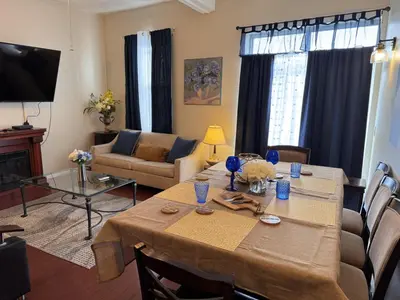 a living room with a table and a couch at Mega Trade Stunning View - APT 3-4 Combination in Union City