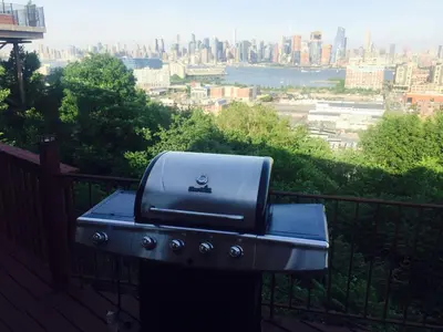 a grill on a balcony with a view of a city at Mega Trade Stunning View - APT 3-4 Combination in Union City