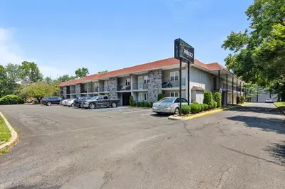 a hotel with cars parked in a parking lot at Chic New York Studio with Kitchen in Hyde Park