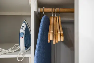 a shelf with a blue iron and some bats at Chic New York Studio with Kitchen in Hyde Park