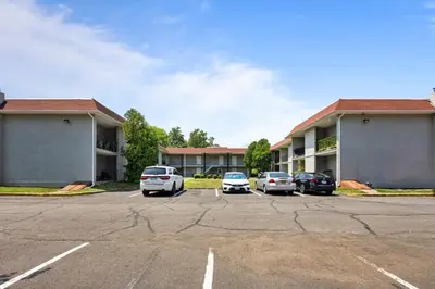 a parking lot with cars parked in front of a hotel at Chic New York Studio with Kitchen in Hyde Park