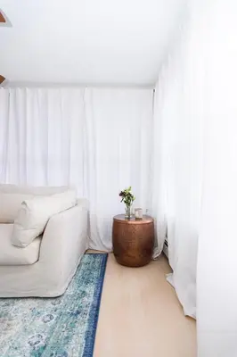 a white living room with a couch and a table at Spacious Beach Vibe Newark's Hidden Gem in Newark