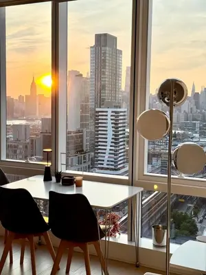 a dining room with a view of the city at 1 Stop to Midtown Amazing View Luxury High Rise Corner 1 Bedroom Apartment in Sunnyside
