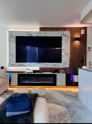 a living room with a large flat screen tv at NEW Modern 2BR w Fireplace & Fitness Lounge, Live Comfortably in East Harlem in New York