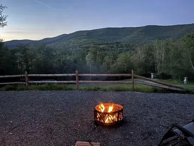 a fire pit with a view of the mountains at Piebald Mountain Pet Friendly Tents, Petersburg, New York