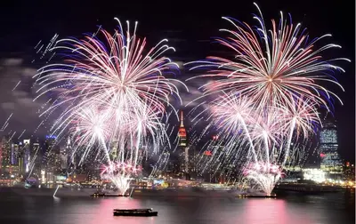 a fireworks display over the water with a city at 5 mins to Midtown Central New Luxury Corner 2b2b Apt with Amazing City View in Long Island City