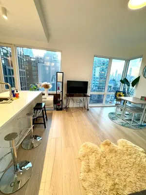 a large living room with a floor to ceiling windows at 5 mins to Midtown Central New Luxury Corner 2b2b Apt with Amazing City View in Long Island City