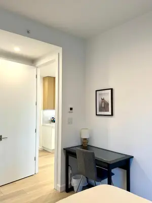 a dining room with a black table and a chair at 5 mins to Midtown Central New Luxury Corner 2b2b Apt with Amazing City View in Long Island City