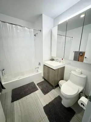 a bathroom with a toilet and a sink and a tub at Luxury 2 bedrooms 2 bathrooms Corner Apartment Breathtaking City Views Modern Retreat in Sunnyside