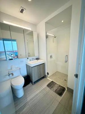 a bathroom with a toilet and a sink and a shower at Luxury 2 bedrooms 2 bathrooms Corner Apartment Breathtaking City Views Modern Retreat in Sunnyside